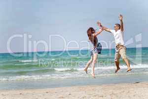 Happy young couple having fun on the beach