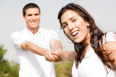 Happy young couple in playful mood focus on woman