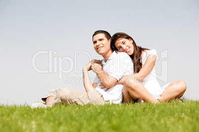 Happy young women with arms around her husband and laying on his