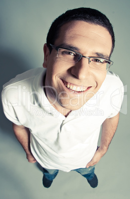 Isolated close-up of a cheerful young man looking up