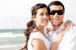 Romantic coupleholding smiling eachother at the beach