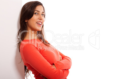 Beautiful young woman standing by the blank baord