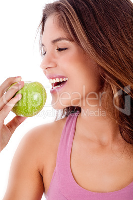 happy young girl ready to bite a green apple