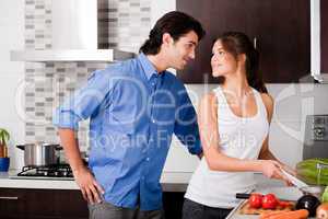 couple starring each other eyes in the kitchen