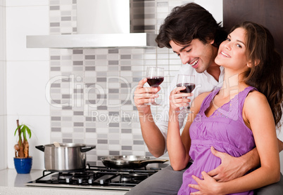 Couple drinking wine in their kitchen