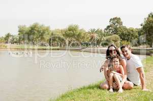 Family sitting near the lake