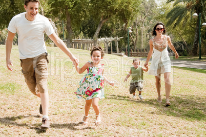 Family running with two young children