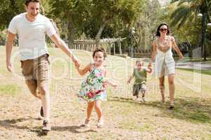 Family running with two young children
