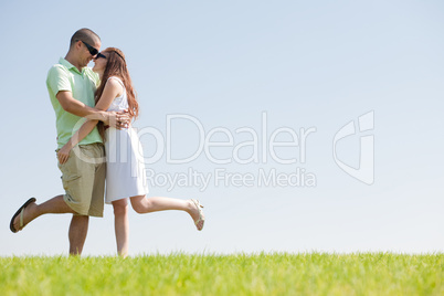 young Couple Fooling Around On The park