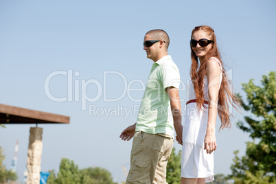 young couple walk on the park