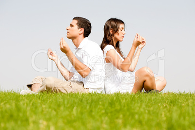 young couple doing meditating
