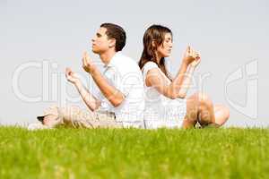 young couple doing meditating