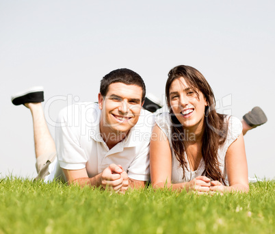 happy Couple lie down on grass