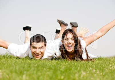 cute young Couple lie down on grass