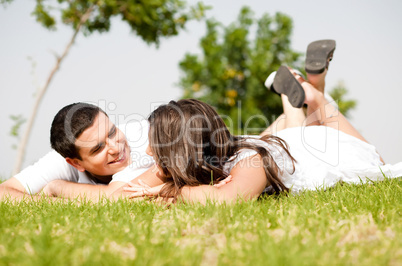 happy young Couple lie down on grass