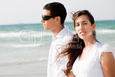 young Cute Couple walk on the beach