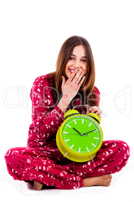 teenager sitting with alarm clock