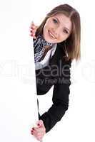 Happy young women peeking through a blank board