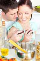 Loving couple preparing spaghetti in the kitchen and drinkng win