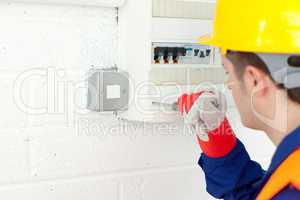 Mature electrician repairing a power plan