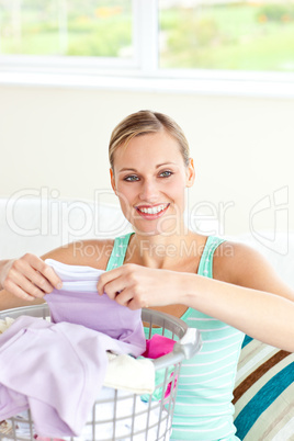 Positive young woman doing the laundry