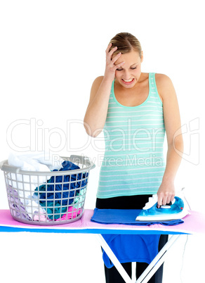 Frustrated woman ironing her clothes