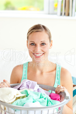 Cheerful young woman doing the laundry