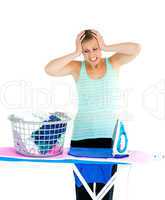 Unhappy woman ironing her clothes
