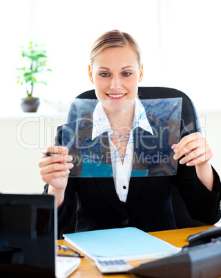 Confident businesswoman preparing slides for a presentation in h