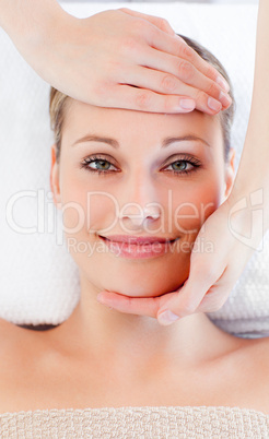 Young smiling woman receiving a head massage