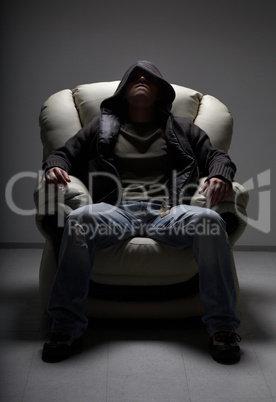 dangerous man sitting in white chair
