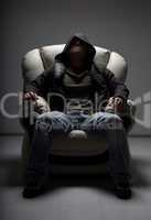 dangerous man sitting in white chair