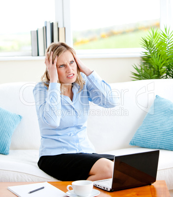 Young businesswoman getting frustrated with a laptop