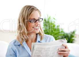 Attractive businesswoman wearing glasses and reading the newspap