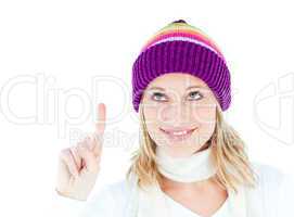 Pretty woman with a colorful hat pointing upwards