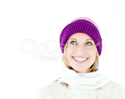 Bright young woman with cap in the winter smiling at the camera
