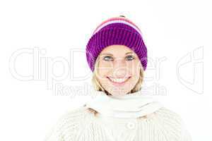 Beautiful young woman with cap in the winter smiling at the came