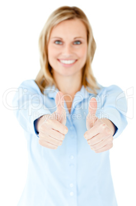 Radiant businesswoman smiling at the camera with thumbs up