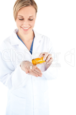 Charming young doctor holding pills