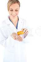 Charming young doctor holding pills