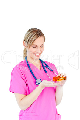 Beautiful young doctor holding pills