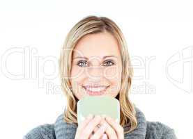 Joyful woman wearing a pullover enjoying a hot coffee