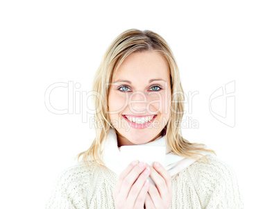Smiling woman wearing a pullover enjoying a hot coffee