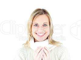 Smiling woman wearing a pullover enjoying a hot coffee