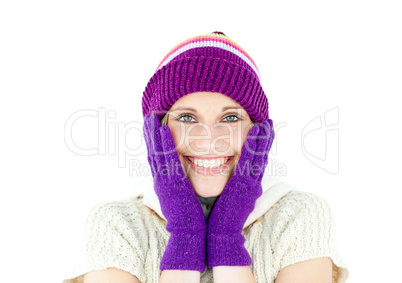 Positive woman with a colorful hat and a pullover smiling at the