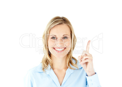 Smiling businesswoman pointing upwards with her finger