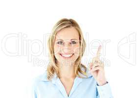 Smiling businesswoman pointing upwards with her finger