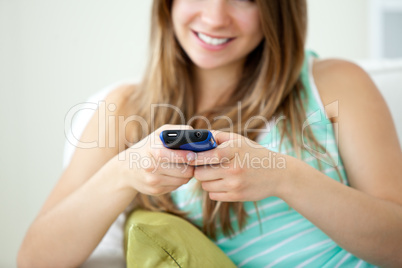 Close-up of a beautiful young woman texting with her cellphone o