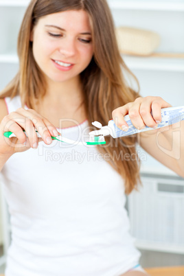 Beautiful woman using a toothbrush and toothpaste in the bathroo