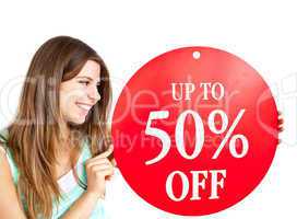 Bright caucasian woman holding a "up to 50% off" red banner